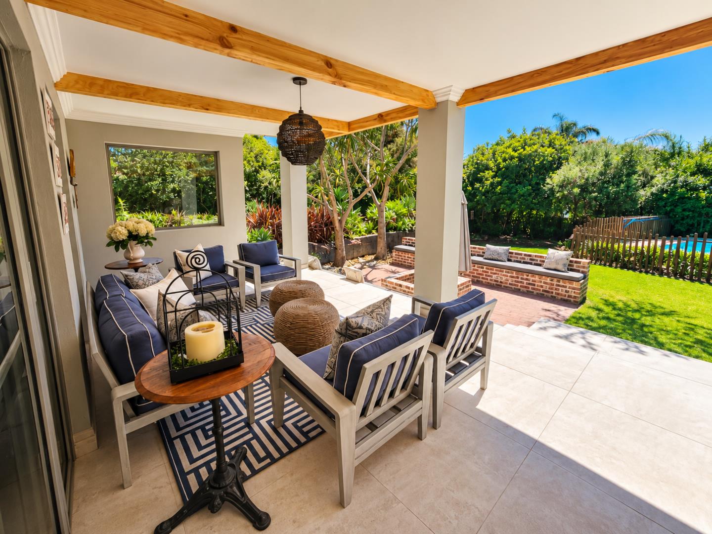 769820_Sunlit_Patio_Lounge_Overlooking_Pool_and_Garden.png